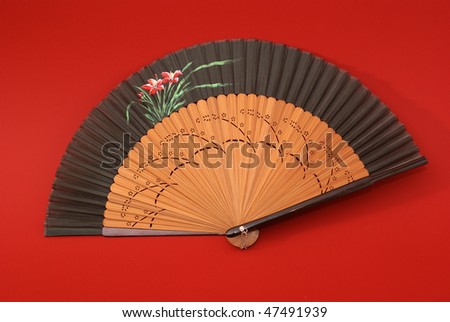 East traditional fan isolated on red background