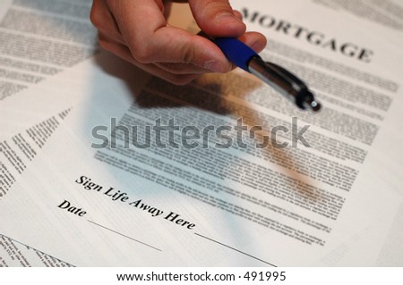 Mortgage Documents with Hand Holding Pen