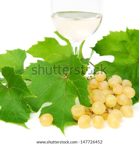 Close up of green grapes and white wine over white. Selected focus