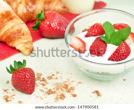 Healthy breakfast with yogurt, fresh strawberries and croissant