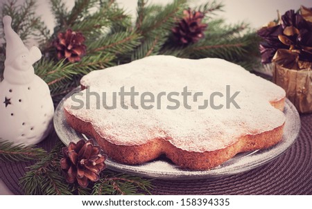Christmas card with traditional fruitcake on plate and christmas decorations, retro style