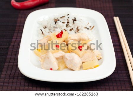 Close up of chicken fillet with pineapple sauce and rice mix, selective focus, horizontal