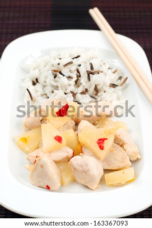 Close up of chicken fillet with pineapple sauce and rice mix, selective focus, vertical