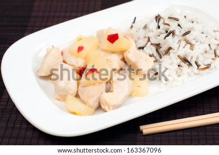 Top view of chicken fillet with pineapple sauce and rice mix, selective focus, horizontal
