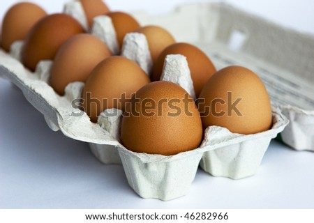 Close up of fresh brown eggs in carton box, selective focus