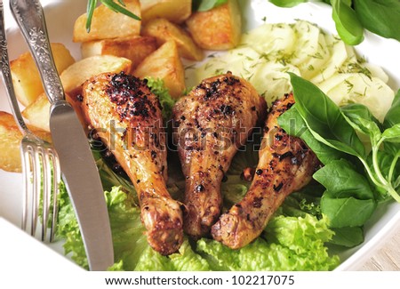 Roast chicken with baked potatoes and cucumber