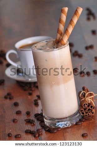 Cold fresh ice coffee with chocolate and cinnamon - close up