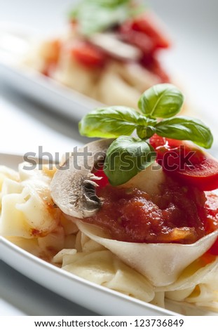 Pasta tagliatelle with tomato sauce and mushrooms