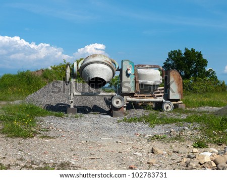 Cement mixers abandoned in field - no action, no work, nobody - metaphor