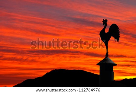 Cockerel weathervane and red sky - sunrise, sunset, new dawn