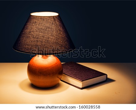 Bedside table light, lamp with book at bedtime
