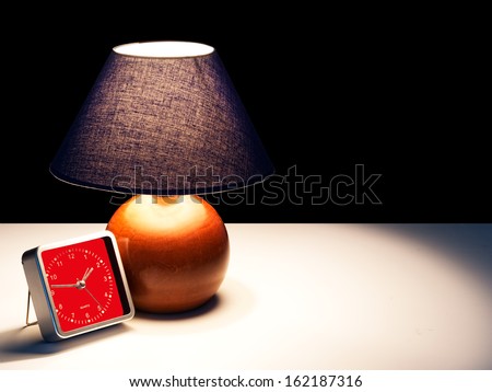 Insomnia, sleepless, alarm clock and bedside lamp