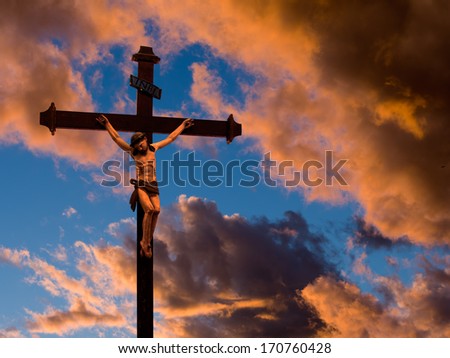 Christian, religious Easter background, church statue against sunset sky