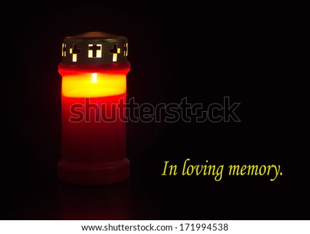 Cemetery, remembrance candle burning in red case - In loving memory, tribute