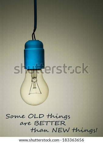 Old things are better than new things - age, love, marriage concept, greetings card with old incandescent light bulb.