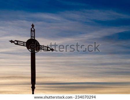 Gentle Easter sunset. Rusty old cross. With copyspace.
