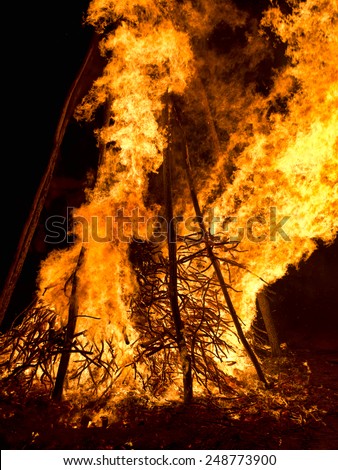 Large bonfire at night. Flames, sparks from celebratory fire