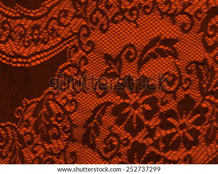 Pretty black lace on red detail, feminine background.