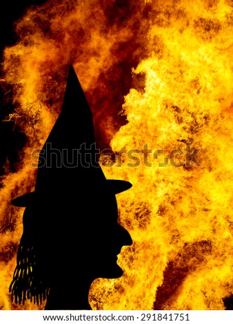 Halloween background. Real flames, not real witch. Silhouette.