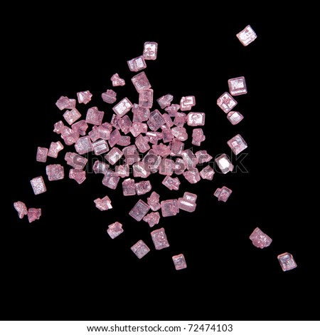 Tiny shiny pink crystals on black background