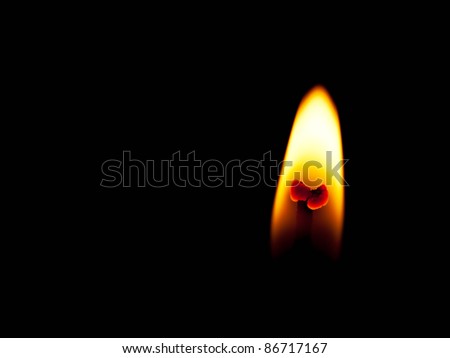 Candle flame macro - light in the darkness, black background