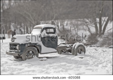 Old truck covered in snow