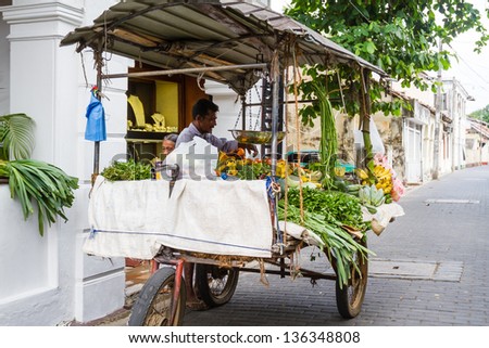 GALLE - MARCH 15: Vendor selling fresh vegetables and fruits, 15 March 2013 in Galle, Sri Lanka. Many people buy fresh food on the street rather than at shops.