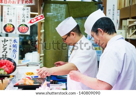 TOKYO - JANUARY 17: Japanese cook prepares sushi in a restaurant on January 17, 2013 in Tokyo. Sushi is the world famous gem of Japanese cooking.