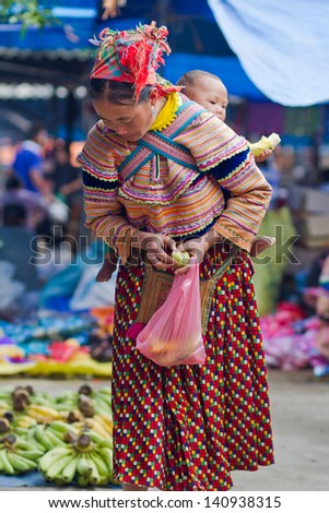 BAC HA, VIETNAM - SEPTEMBER 21: Unidentified women of the Flower H\'mong Ethnic Minority People at market on September 21, 2012 in Bac Ha, Vietnam. H\'mong are the 8th largest ethnic group in Vietnam.