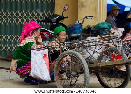 BAC HA, VIETNAM - SEPTEMBER 21: Unidentified women of the Flower H\'mong Ethnic Minority People at market on September 21, 2012 in Bac Ha, Vietnam. H\'mong are the 8th largest ethnic group in Vietnam.
