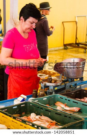 SPLIT, CROATIA - MAY 10: An unidentified woman sells fish at a local market on May 10, 2013 in Split, Croatia. Croatia with its hundreds of islands is a unique area for variety of fishes.
