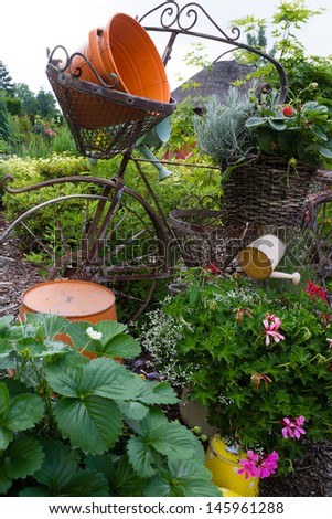 Model of an old bicycle equipped with baskets of flowers.