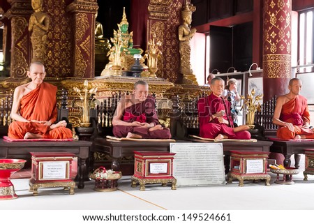 CHIANG MAI, THAILAND - JULY 31; Statues of praying monks in a buddhist temple on July 31, 2012 at temple in Chiang Mai, Thailand. Meditation is a buddhist way of praying.