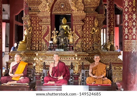 CHIANG MAI, THAILAND - JULY 31; Statues of praying monks in a buddhist temple on July 31, 2012 at temple in Chiang Mai, Thailand. Meditation is a buddhist way of praying.
