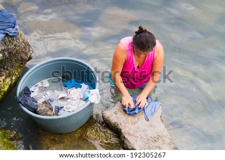 LAKE ATITLAN, GUATEMALA - APRIL 23: Mayan inigenous women wash clothes and take bath on the coast of San Pedro La Laguna, Lake Atitlan, Guatemala on April 23, 2014.