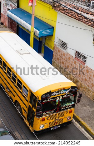 SANTA ANA, EL SALVADOR - MAY 07: School bus stops at the bus stop in Santa Ana, El Salvador on May 07, 2014.