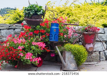 Decorative model of an old bicycle equipped with baskets of flowers.
