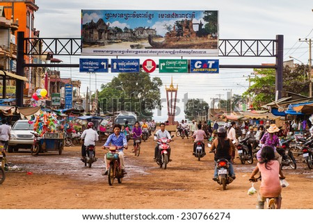 RATANAKIRI, CAMBODIA - SEP 20: People drive down the street in Ratanakiri, Cambodia on Sep 20, 2011. Scooters are very popular means of transportation in Cambodia.