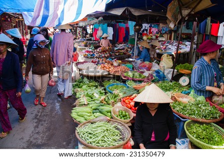 HOI AN, VIETNAM - SEP 5: Woman selling fruits at the market in Hoi An city, east Vietnam on Sep 5, 2011. Fruits and vegetables of local origin are a common sight on the market.