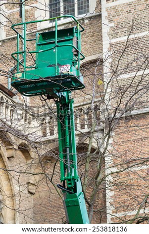 AMSTERDAM, THE NETHERLANDS - NOVEMBER 10: The cage and arm of a mechanical cherry picker lift on November 10, 2014 in Amsterdam, The Netherlands. Cherry-picker is used to hoist the builder safely.