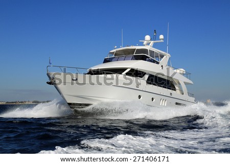 Elegant and graceful luxury power boat underway off Palm Beach, Florida
