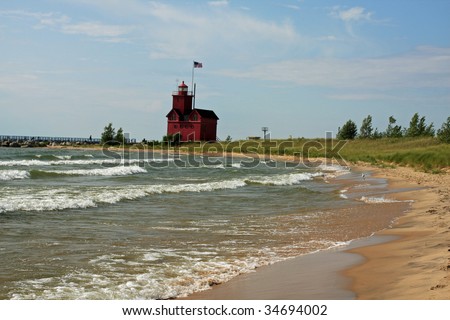 Attractive beach and red lighthouse on Lake Michigan, near Holland, Michigan