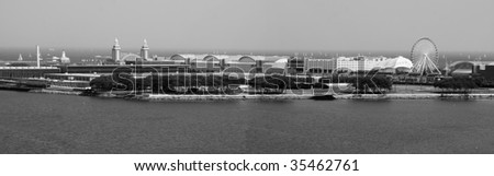 Panorama of Chicago\'s Navy Pier amusement park and rides, as well as Lake Michigan.  Black & white version.