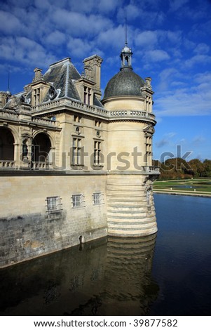 Chateau in Chantilly, France with moat and gothic architecture