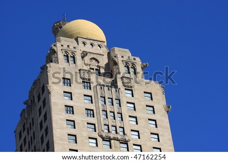 Attractive architecture with birds a yellow dome and gargoyles on this vintage building