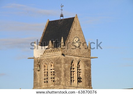 Airborne paratrooper gets stuck on a church in Saint Mere Eglise in Normandy during World War II