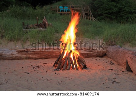 Inviting campfire on the beach on the shore of Lake Michigan in the summer