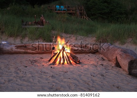 Inviting campfire on the beach on the shore of Lake Michigan in the summer