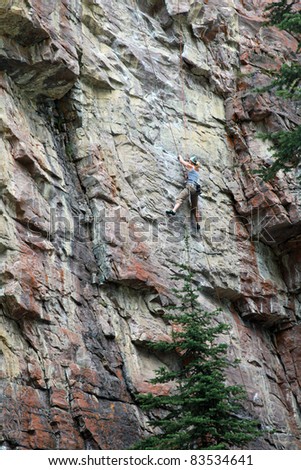 Attractive, strong and fit female rock climbing in Banff National Park near Lake Louise in Canada