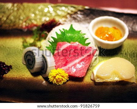 Sashimi ( Japanese fresh raw seafood salad ) - Maguro ( fresh raw tuna ) and calamari and scallop and sea urchin